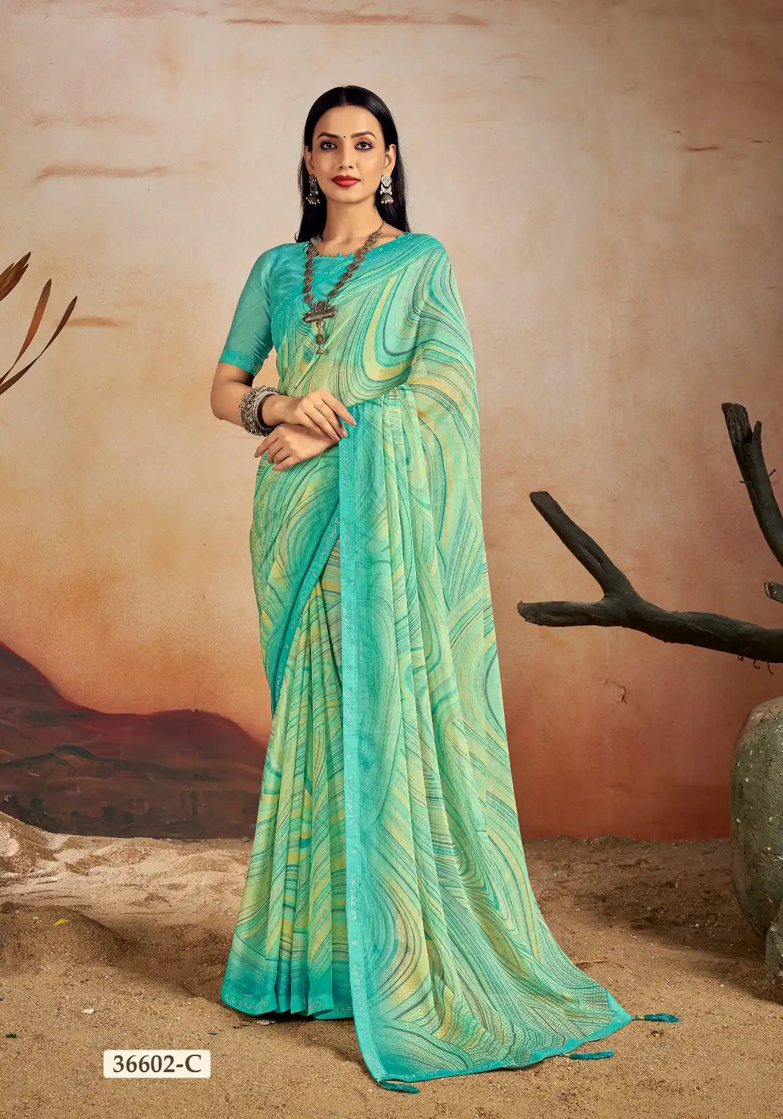 Ruchi Chiffon Saree Features A Delicate Chiffon Fabric Enhanced With A Border Embellished With Crystal